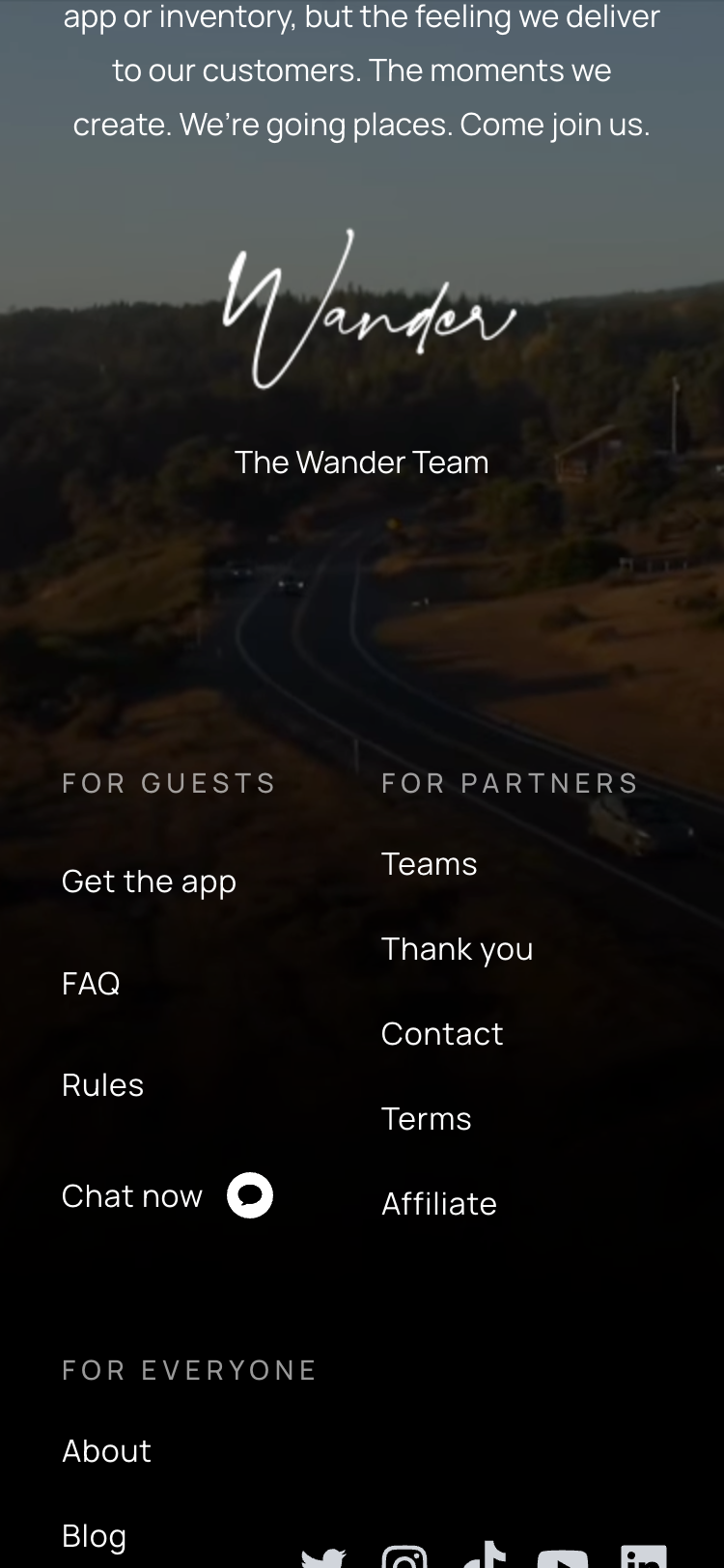 The footer of the Wander homepage on a mobile device. Above the footer is a message from the Wander team that ends with a handwritten signature saying 'Wander.'